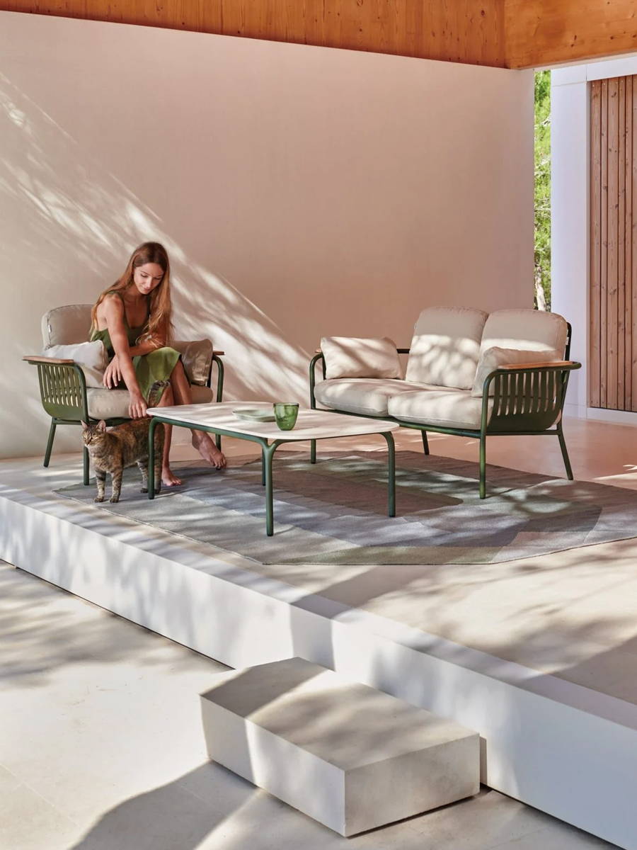 petite patio set with green metal frame and cream cushions