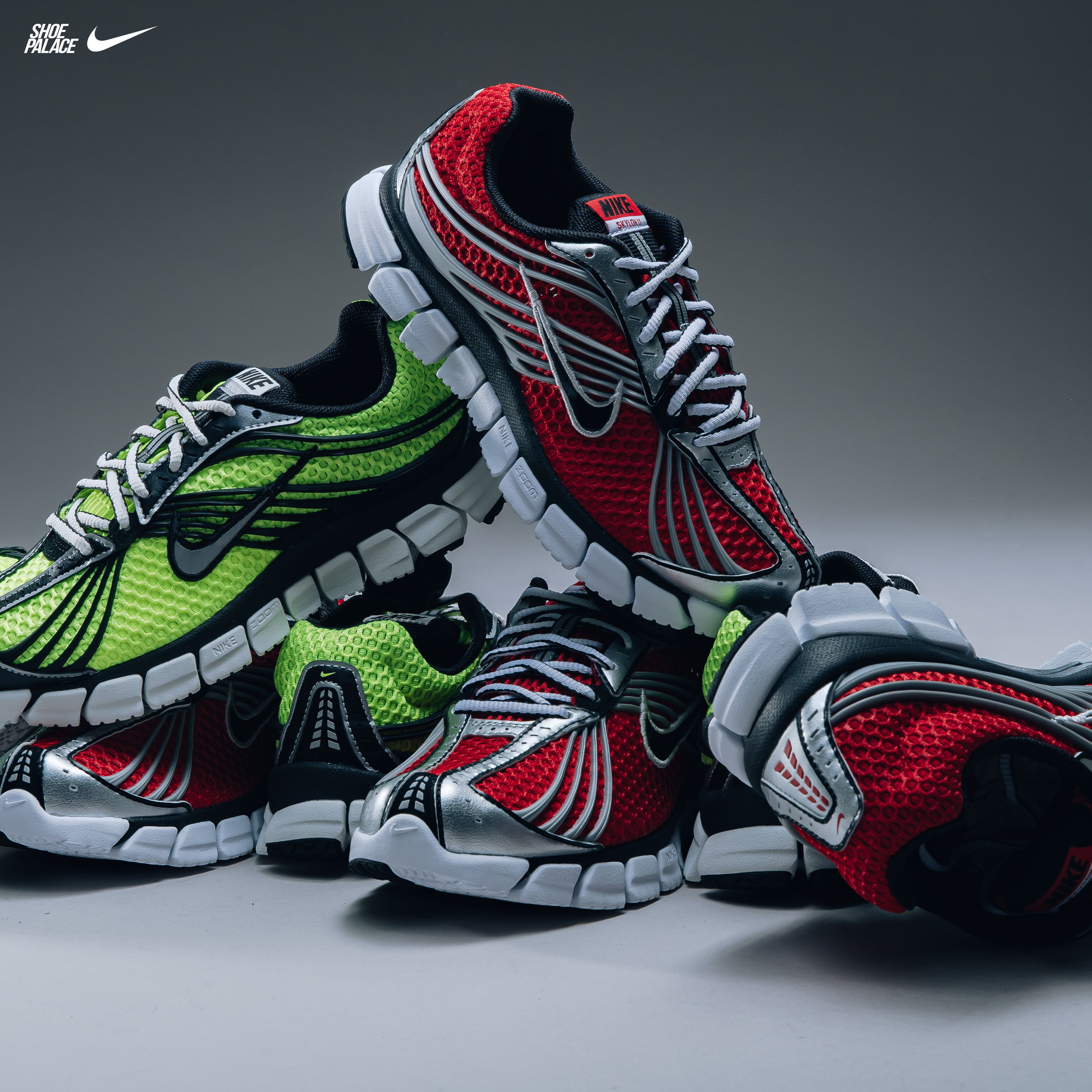 A stack of colorful Nike running shoes in red, green, and black.