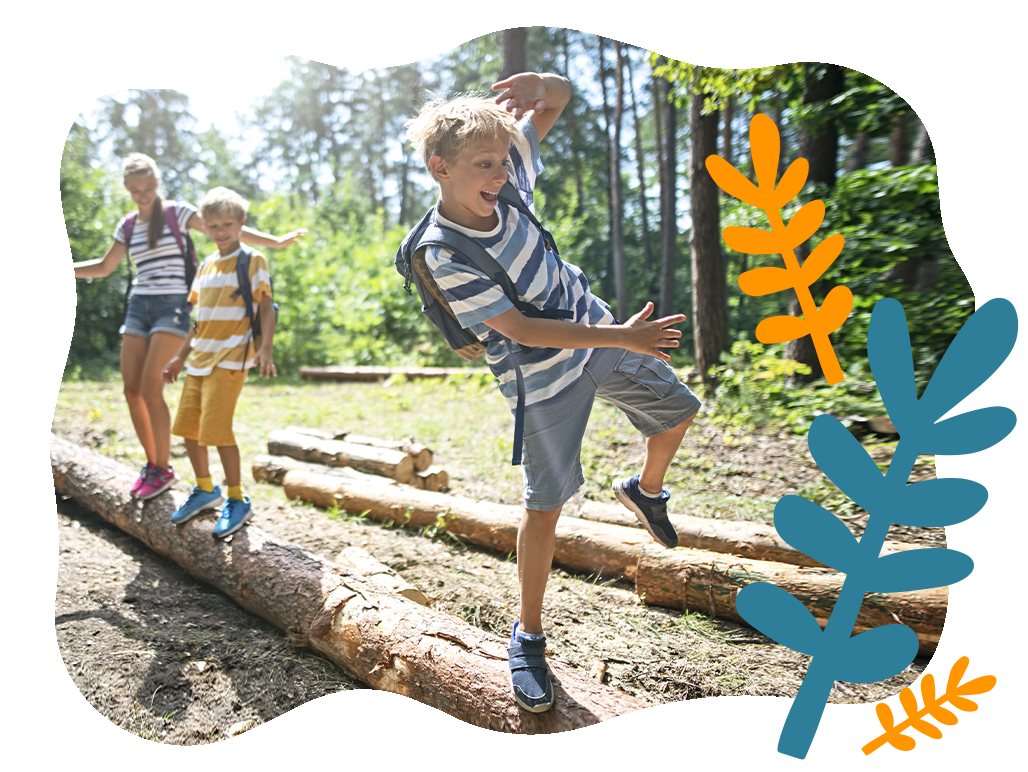 Kids playing balancing on a log outside- Babo Botanicals