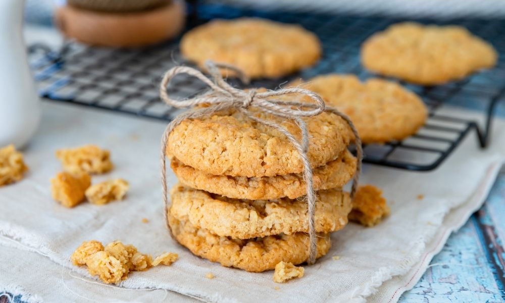 A stack of cookies tied with twine on a cooling rack.