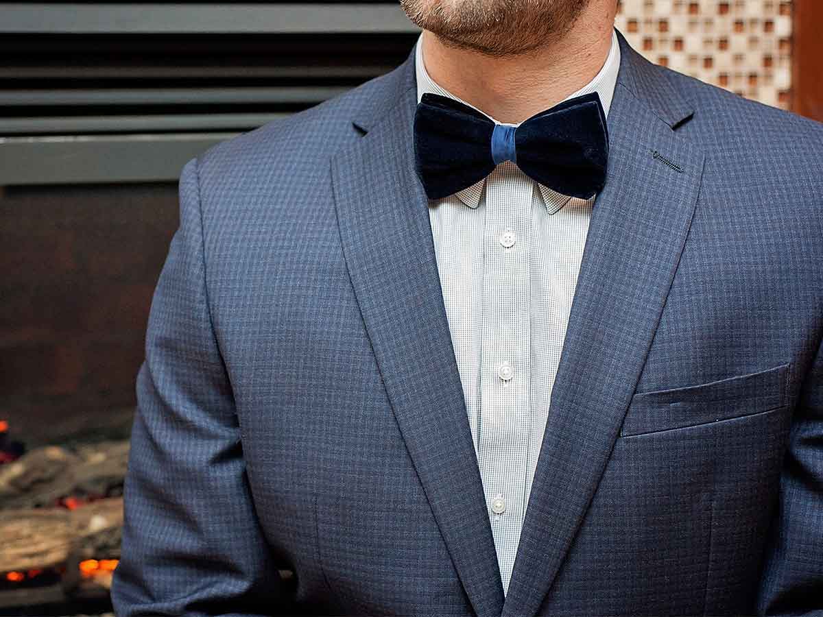 Man wearing a navy velvet bow tie