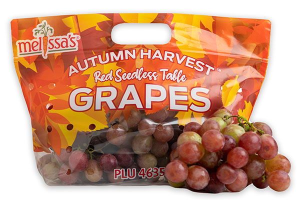 A bag of red seedless grapes with autumn-themed packaging.