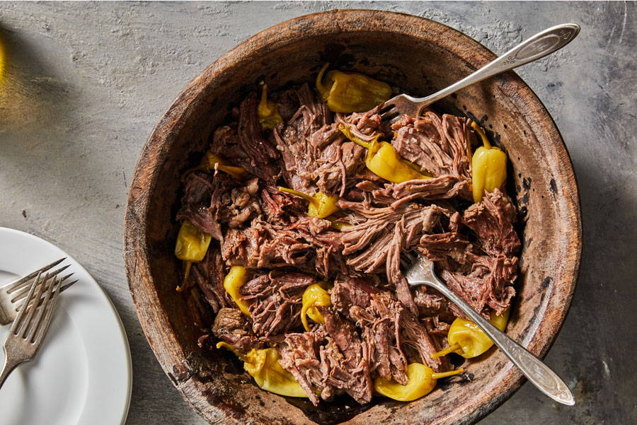 Shredded pot roast with pepperoncini peppers served in a bowl
