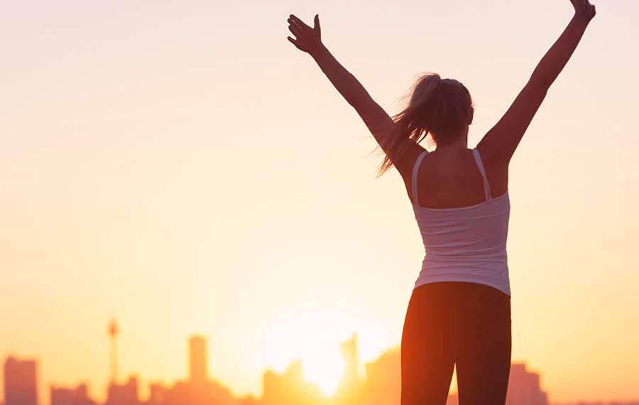 woman with arms in air victoriously