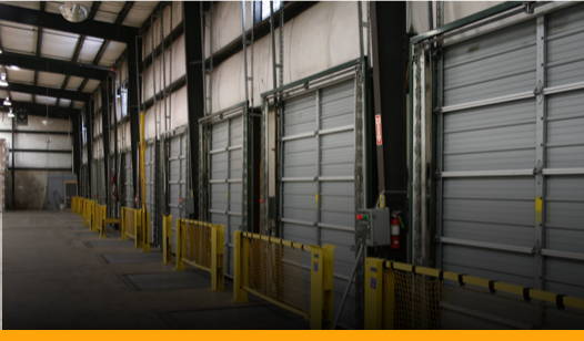 loading docks with yellow barriers in front to prevent injuries