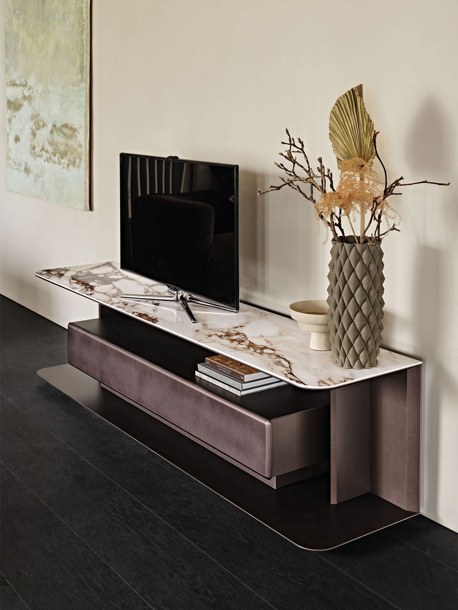 Modern living room with a TV stand, decorative vase, and minimalist decor.