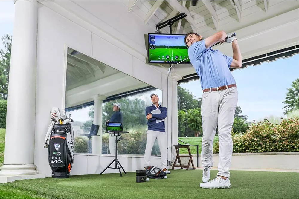 Golfers using the SkyTrak launch monitor at the range