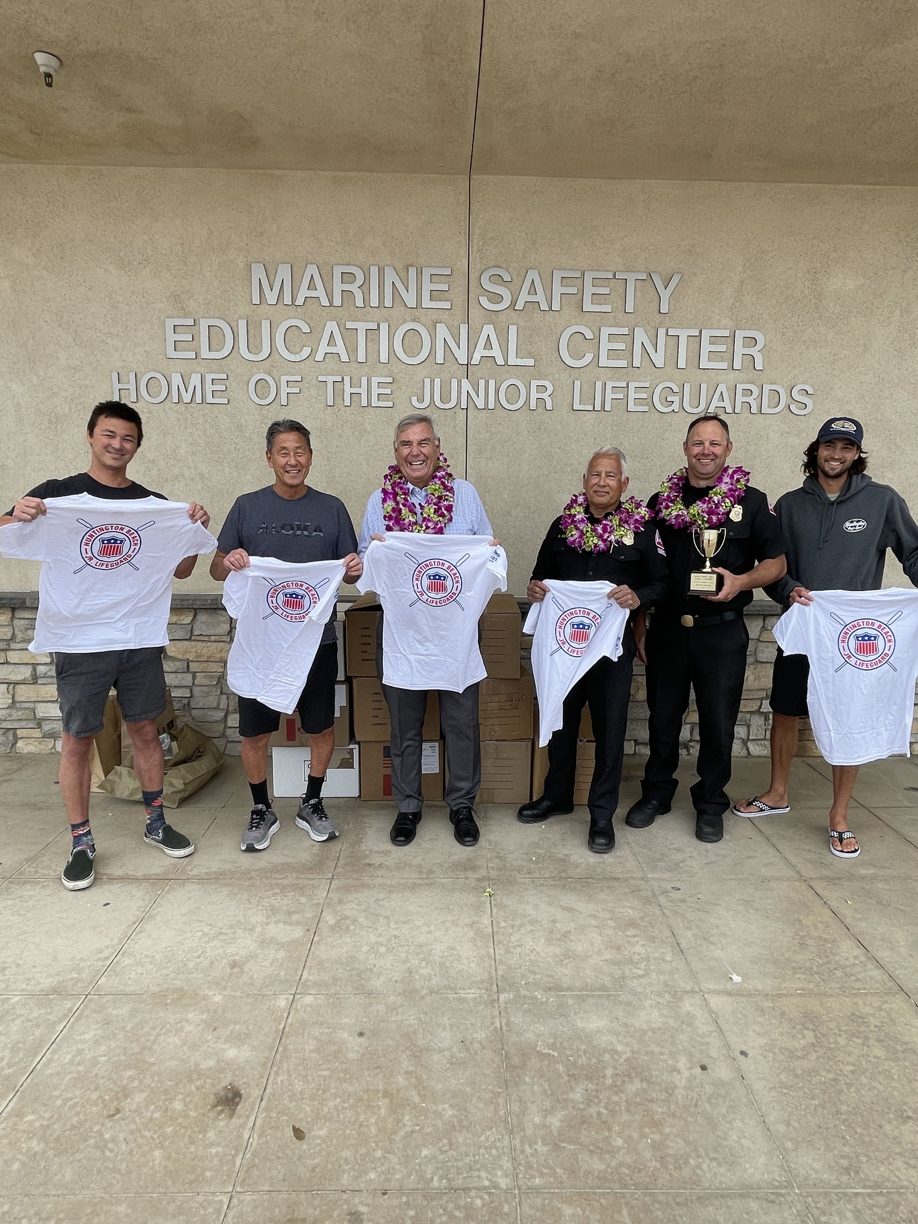 6 people standing in front of Marine Safety Center Holding Jr Lifeguard shirts