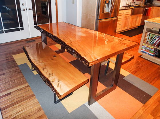 A live-edge wooden epoxy table top with two epoxy-coated benches, made using UltraClear Table Top Epoxy.