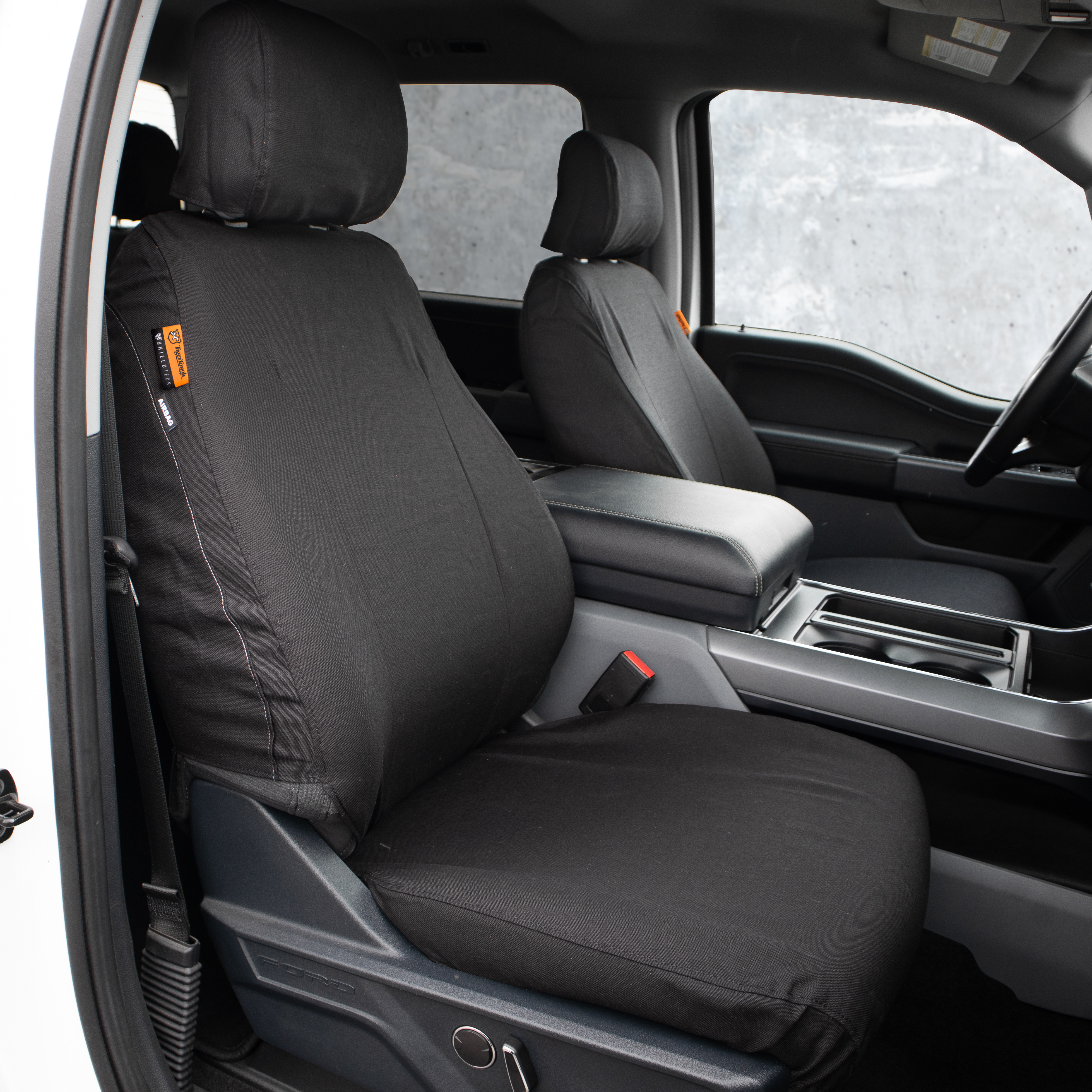 Interior of a Ford truck with black TigerTough seat covers installed