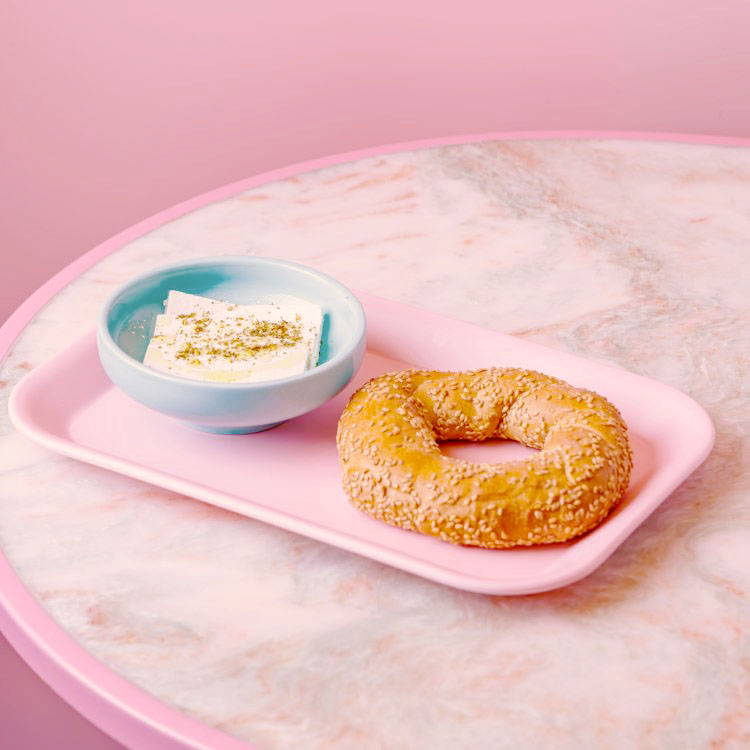 Feta breakfast side with simit bread on pink tray
