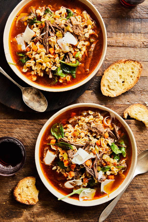 A tomato broth with shredded beef, ditalini pasta, carrots, celery, and parmean cheese.