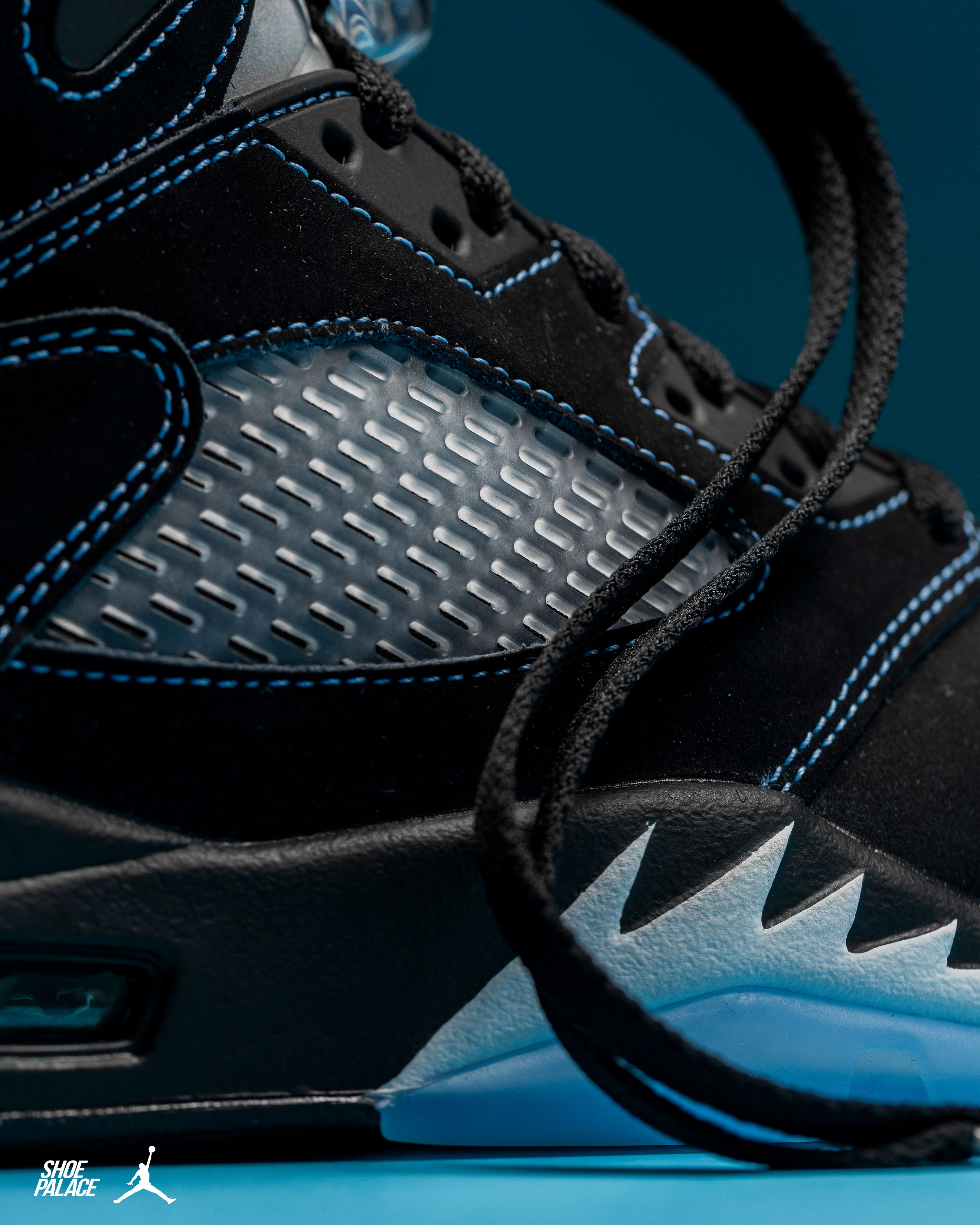 Close-up of a black and blue sneaker with laces.