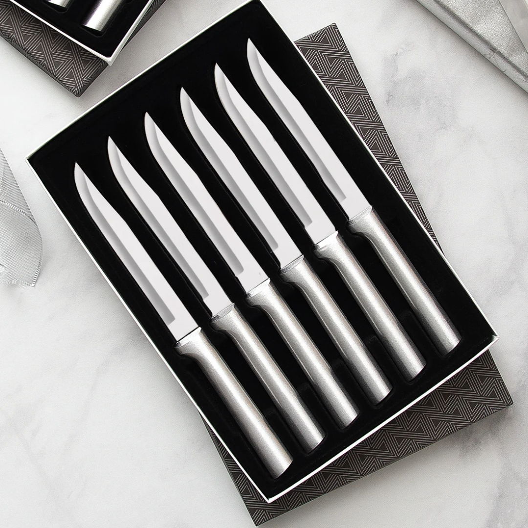 A set of five stainless steel knives in a black box.