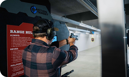 Person shooting at a target in a shooting range.