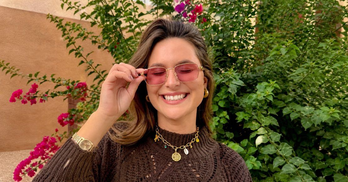 Woman wearing rose tinted fl-41 glasses for migraines