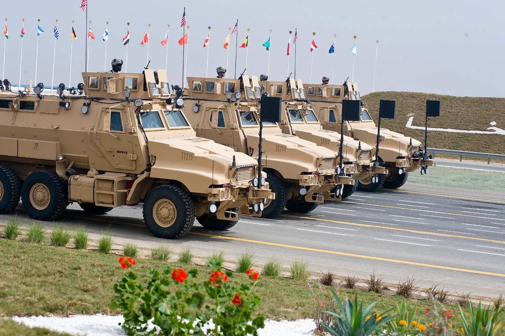 U.S. Army Caiman vehicles make a pass and review on the parade grounds as part of the 50/20 Celebration parade in Kuwait Feb. 26. U.S. forces, along with troops from multiple nations were invited to Kuwait to take part in Kuwait’s 50/20 Celebration, honoring 50 years of Kuwait’s independence and the 20 years of liberation. Kuwait and the U.S. have shared a strong relationship since Operation Desert Storm and continue to build upon an enduring partnership between nations.