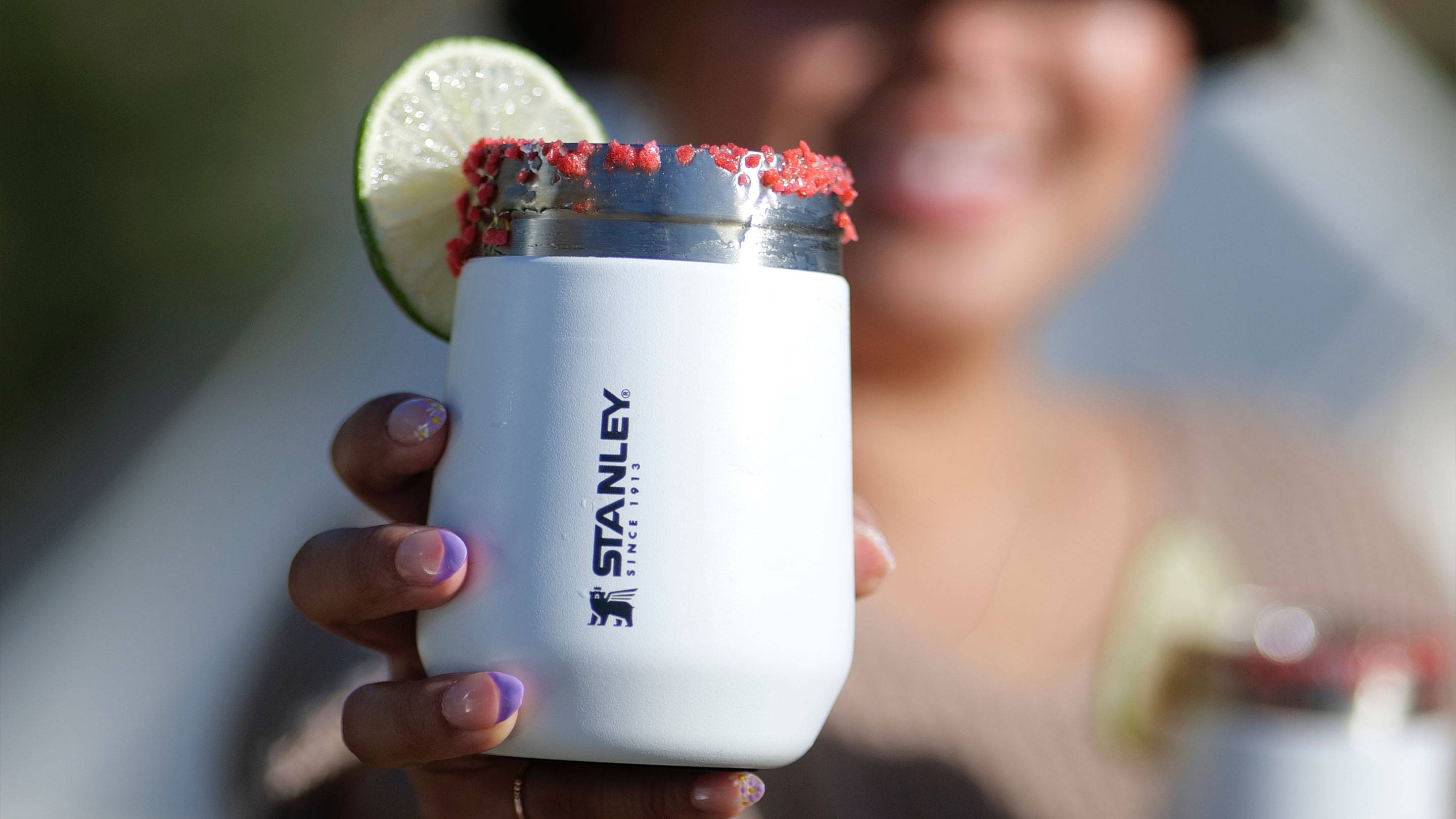 Stanley’s insulated GO Everyday Wine Tumbler in Polar with a lime wheel on the rim.