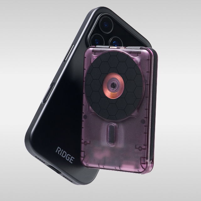 A black phone with a purple accessory attached to it.