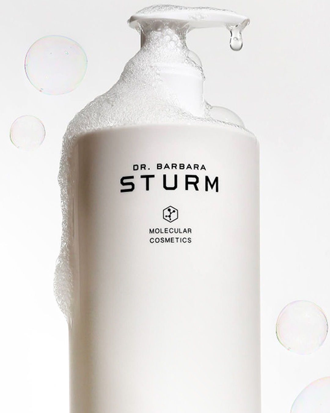 White bottle of Dr. Barbara Sturm Molecular Cosmetics with foamy top.