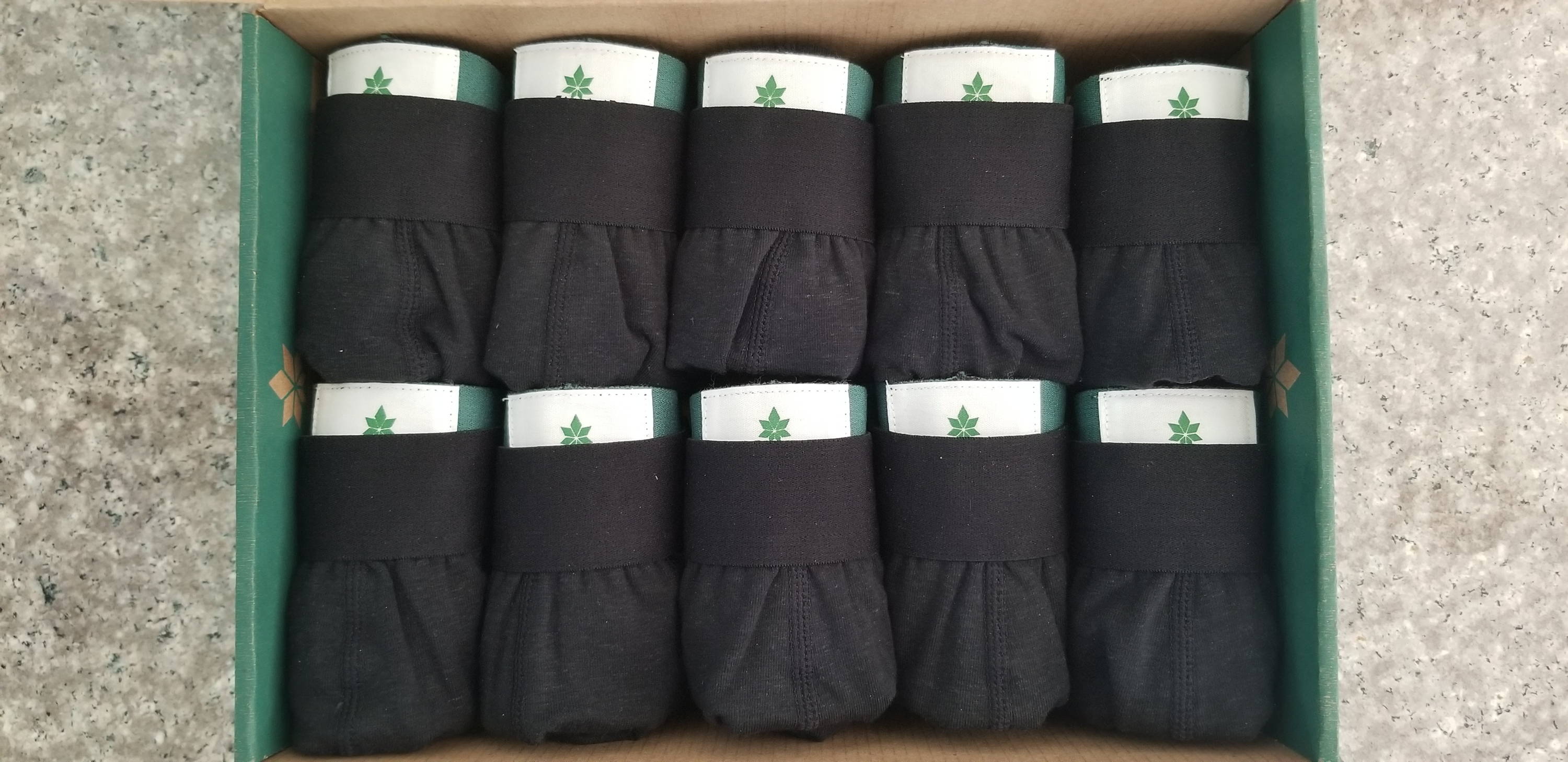 A box full of neatly folded black WAMA hemp underwear using best practices for how to fold underwear. 