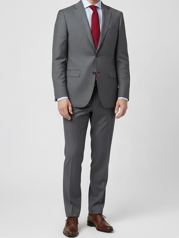 Man wearing a gray suit with crimson geometric necktie