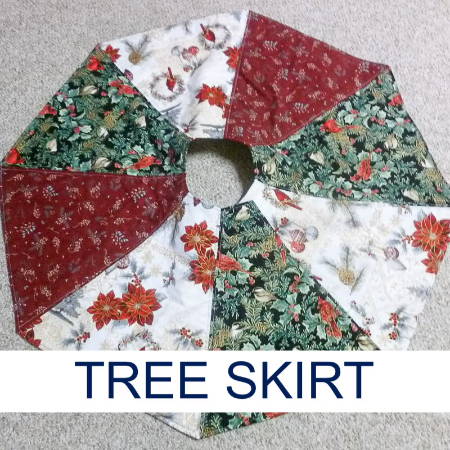 quilted Christmas tree skirt made out of red, white, and green holiday fabrics