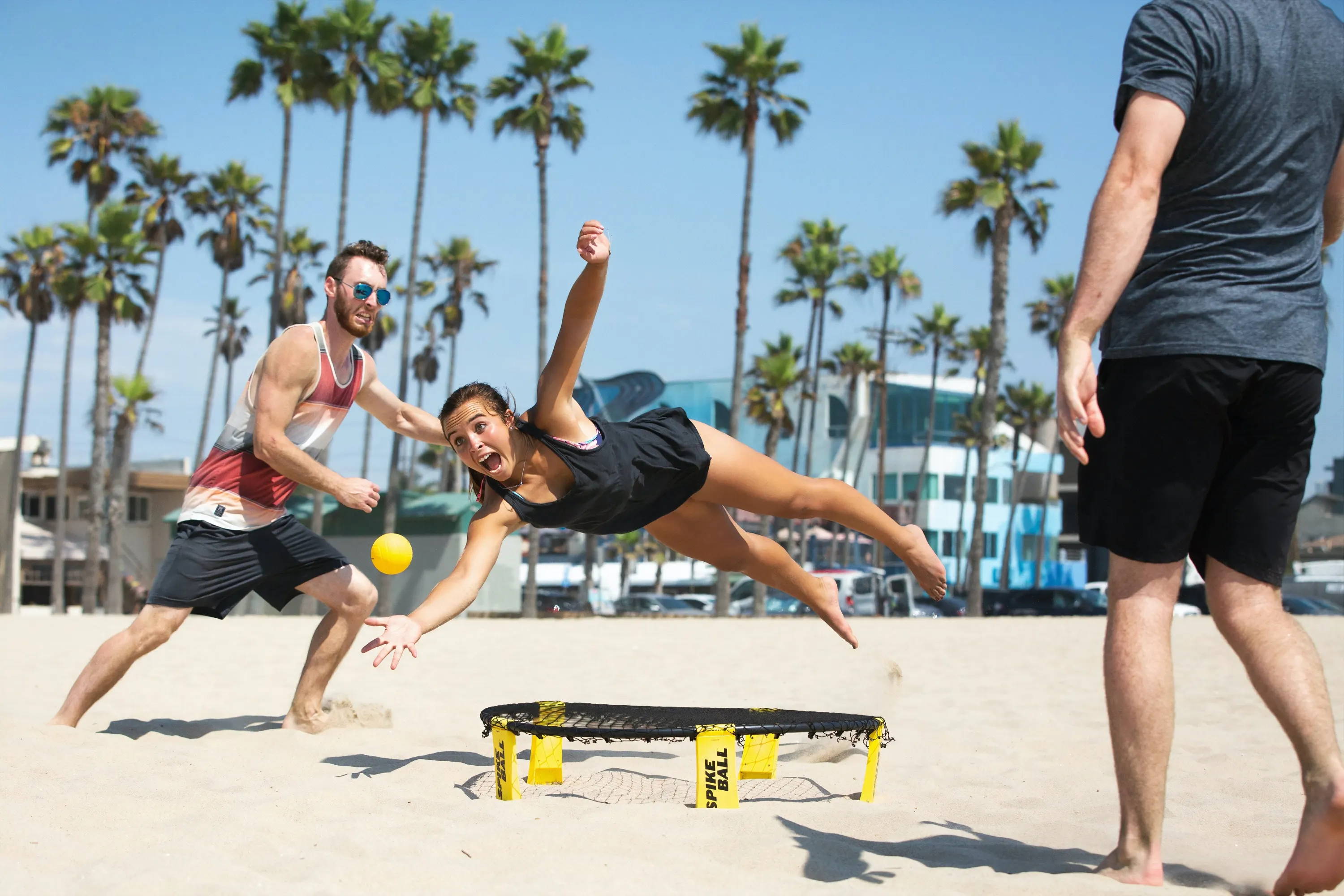 Spikeball player diving for the ball