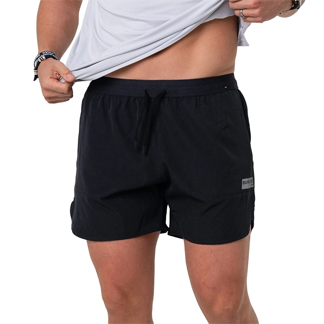 Man wearing black shorts and a gray shirt.