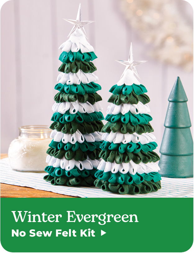 Decorative felt Christmas trees in green and white, with a star on top.