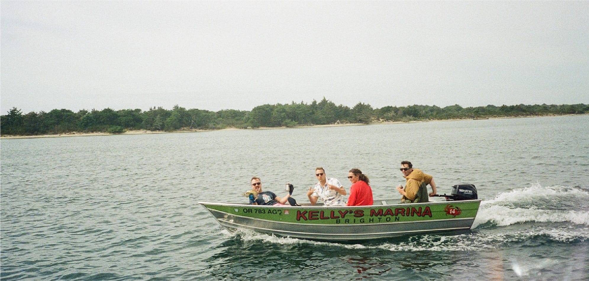 Rumpl team in a boat in Brighton Oregon at Kelly's Marina