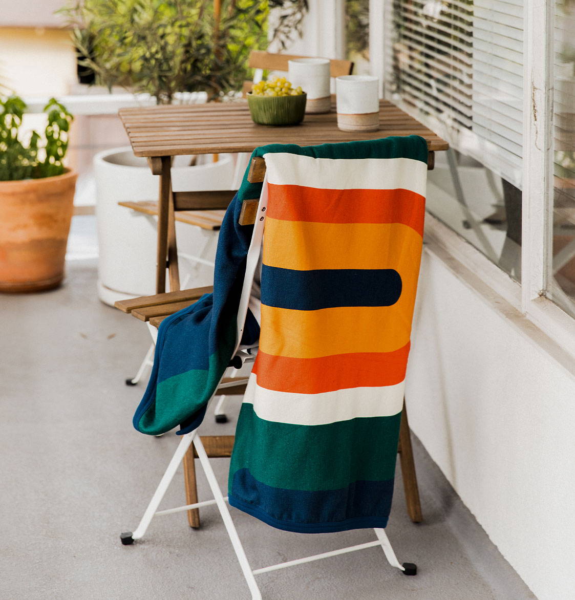 CozyHemp Blanket Hanging off chair on porch