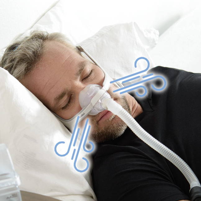 Man sleeping with a CPAP mask in bed.