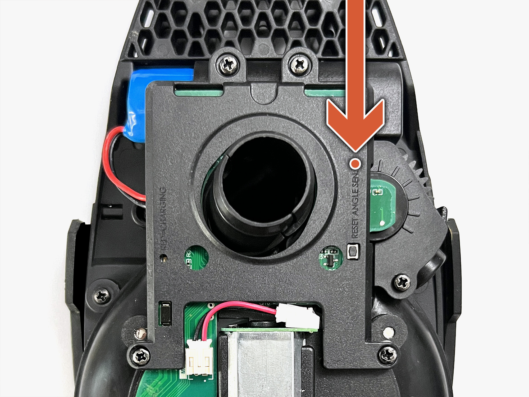 Close-up of a disassembled device showing internal components and an arrow indicator.