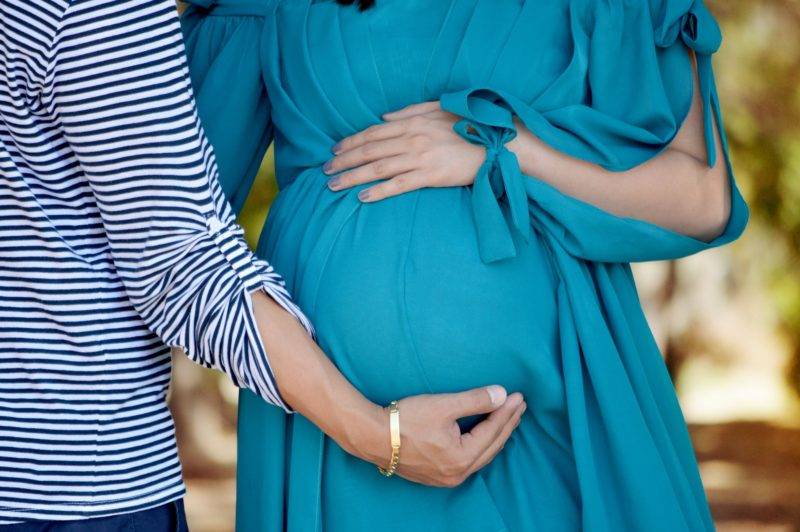 Women Holding Pregnant Stomach