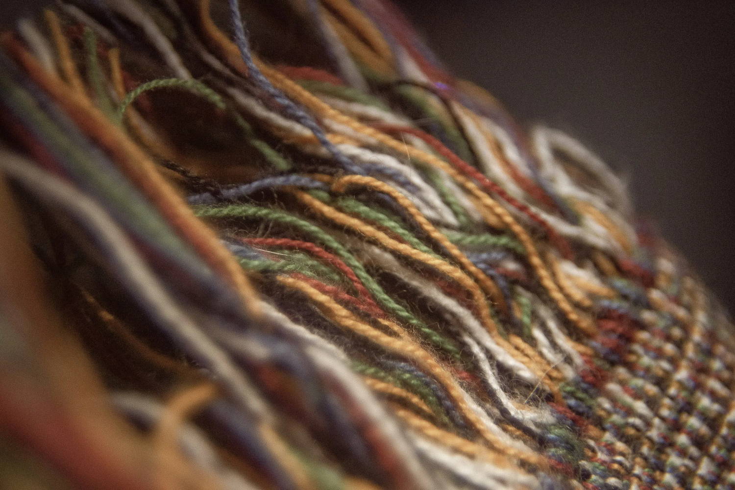 Macro shot of some threads at the edge of a blanket.