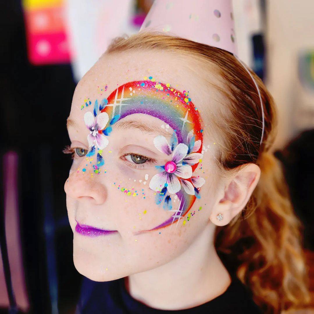 rainbow and flowers face paint girl