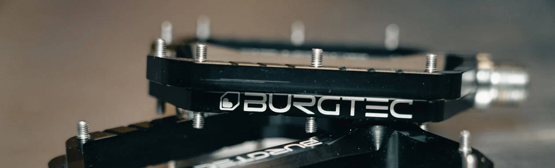 Burgtec Penthouse MK5 Black MTB pedals stacked on each other