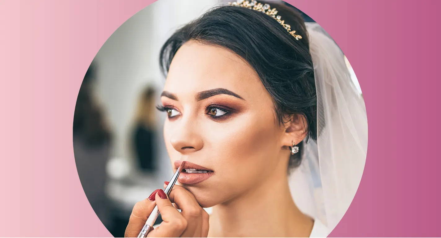 A profesional makeup artist adding makeup for a wedding