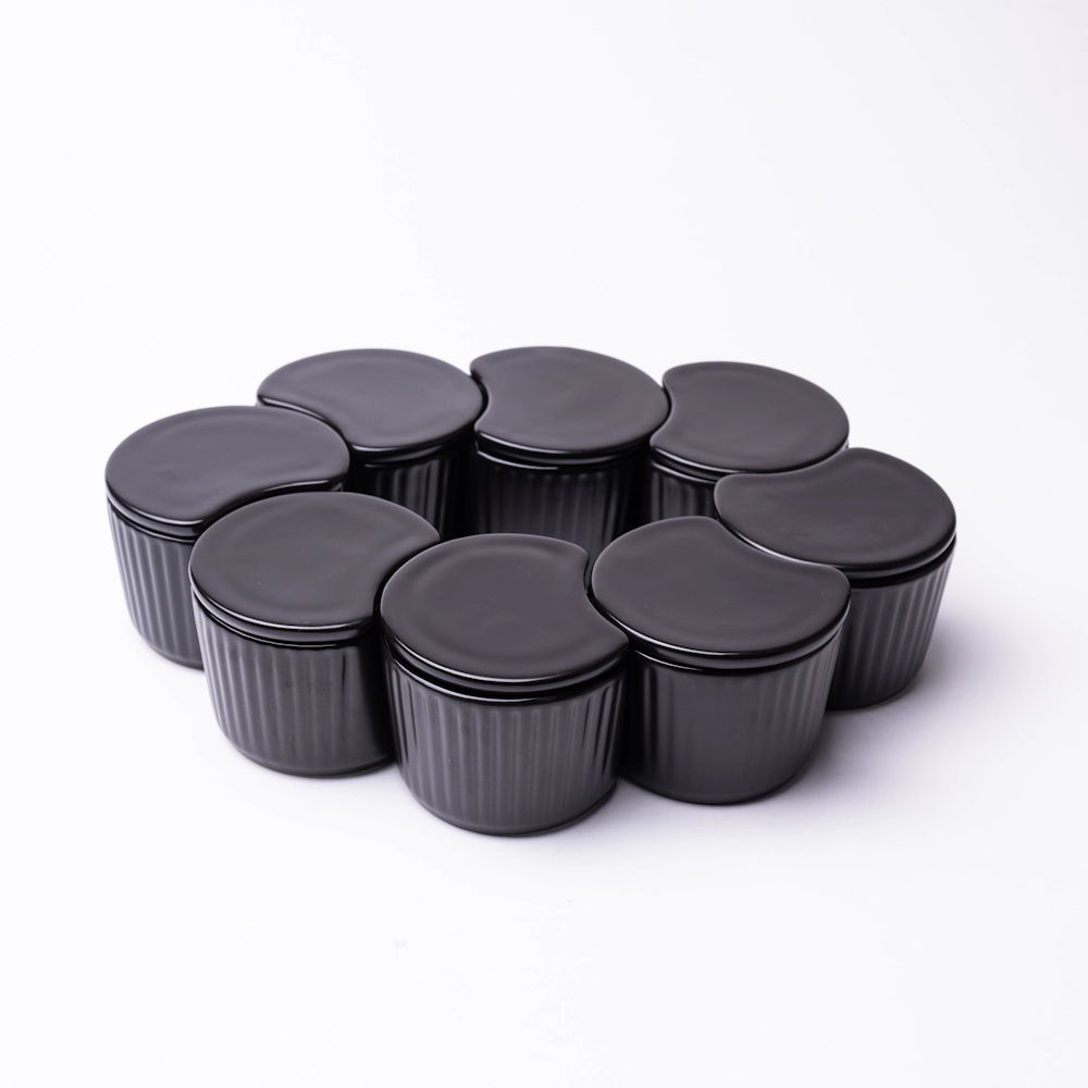 A group of black plastic containers arranged in a circular pattern.
