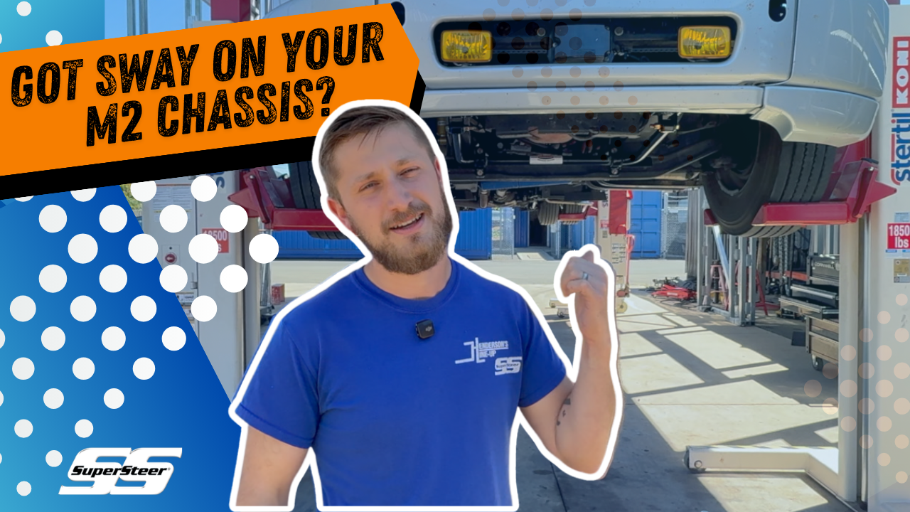 Person gesturing with a vehicle on a lift; text about M2 chassis sway.