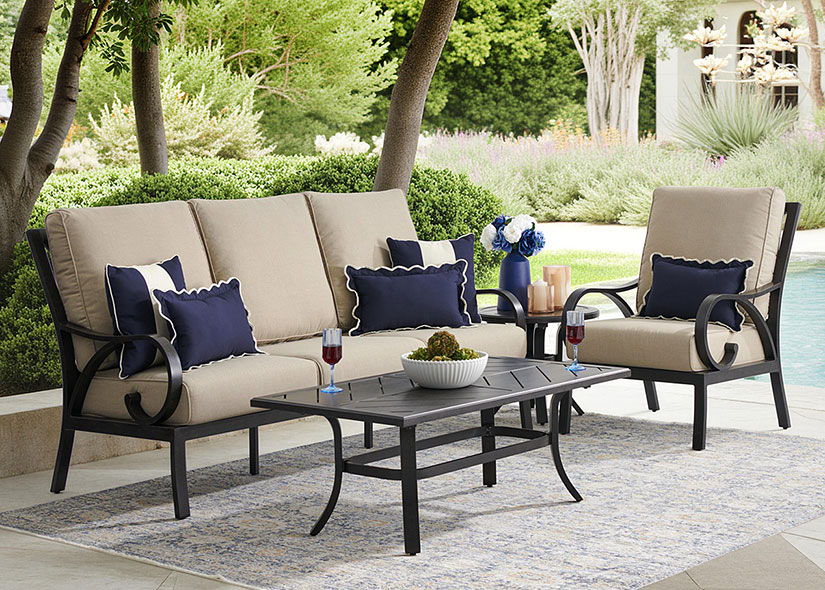 Outdoor seating area with a sofa, chairs, and a coffee table.