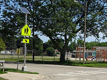 Rectangular rapid flashing beacon installed outside school