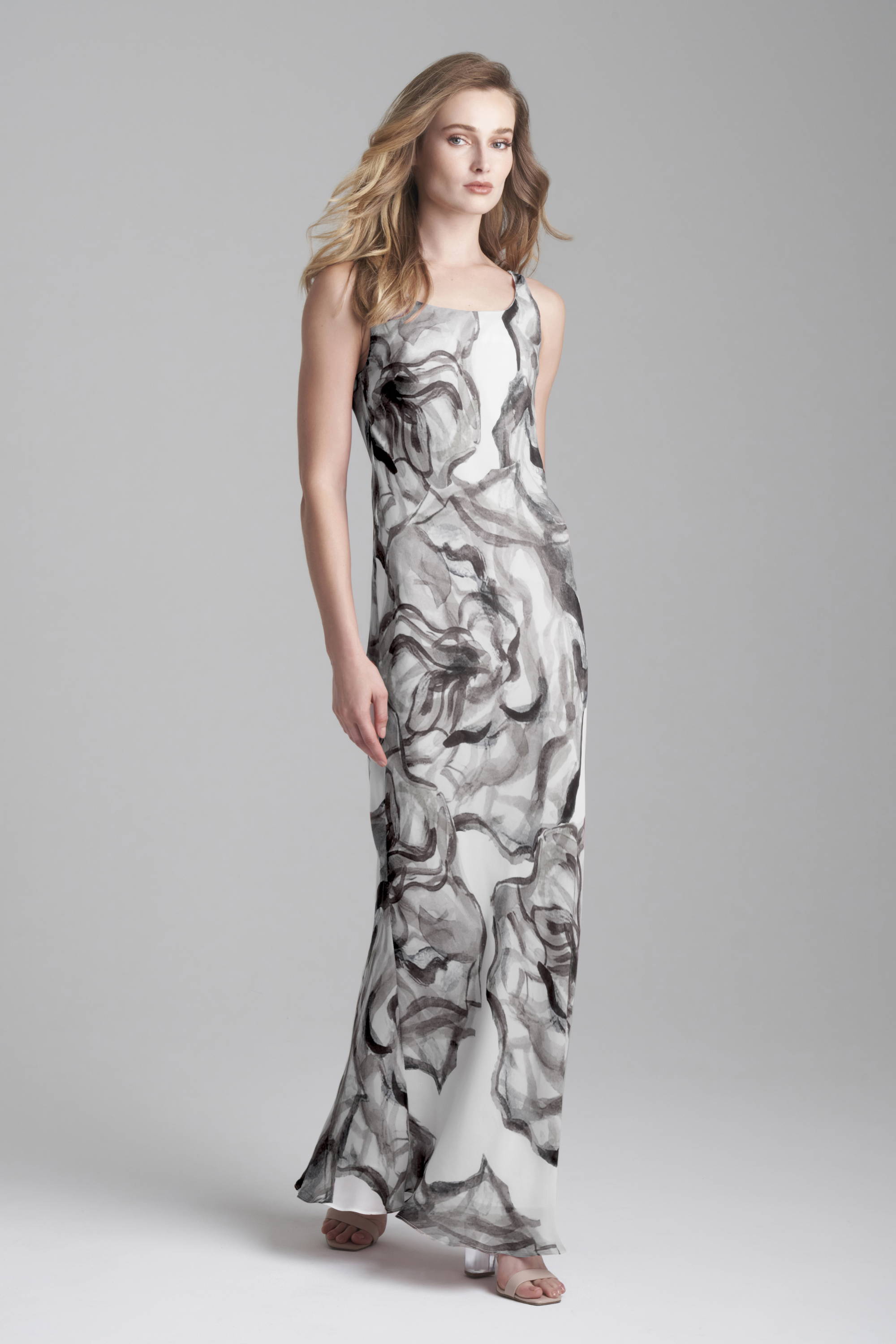 Woman wearing black and white rose printed silk long dress by Ala von Auersperg