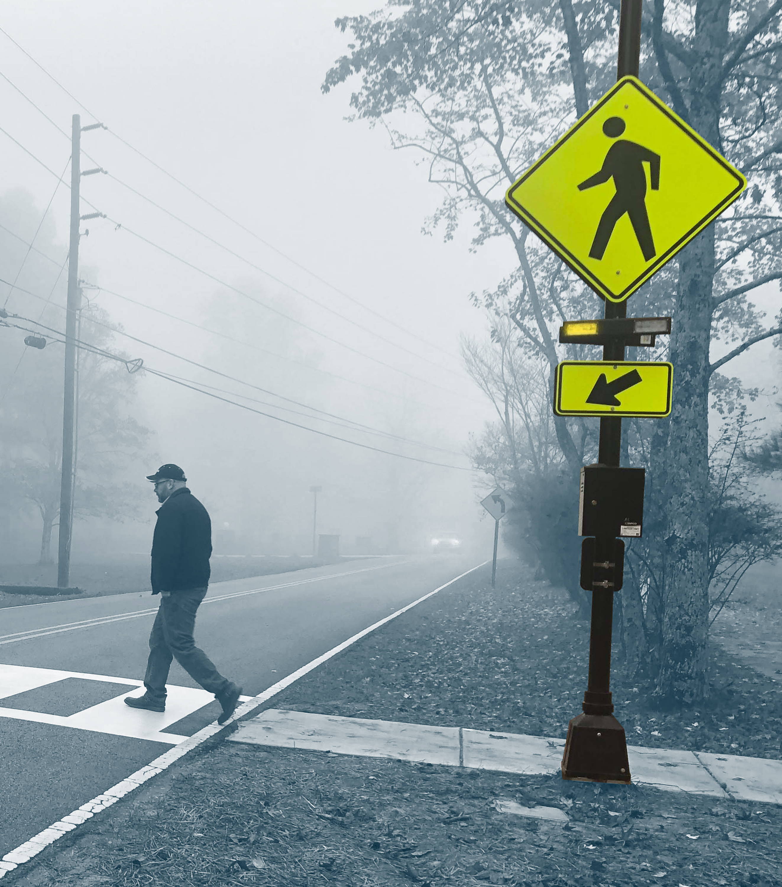 A pedestrian enters an activated RRFB crosswalk.