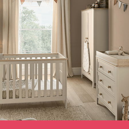 A cozy nursery with a crib, dresser, and natural light.
