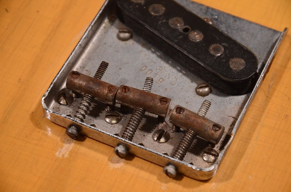 Metal box with mechanical components and springs inside.