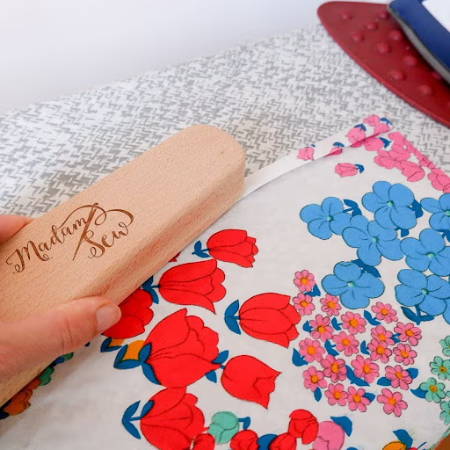 Clapper used to flatten a hem on delicate fabric