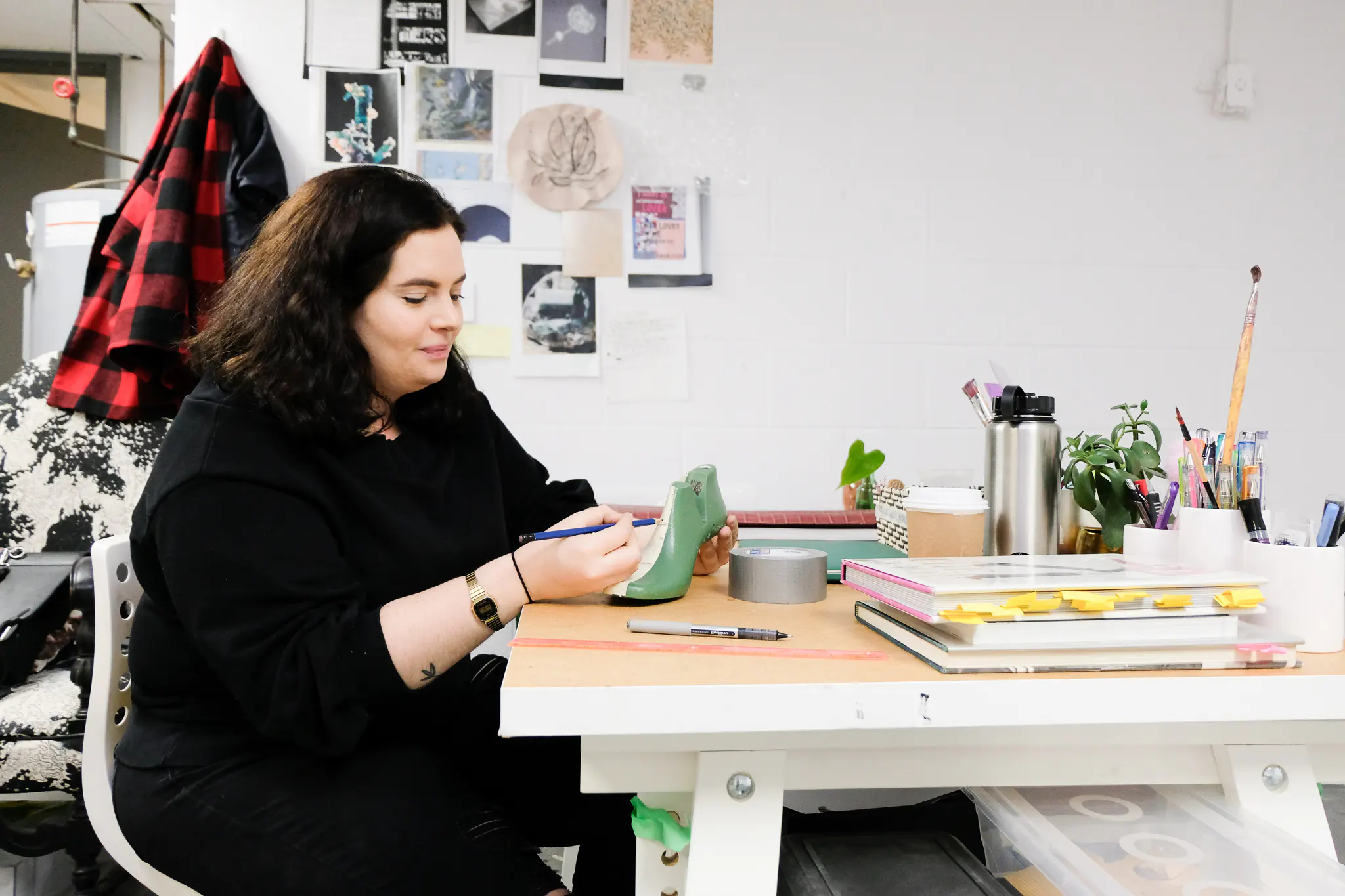 Adria painting at her workbench 