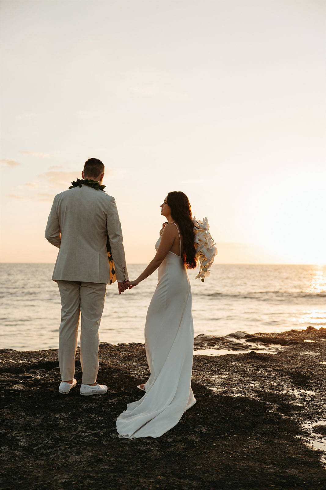 Husband and wife overlooking ocean in Hawaii